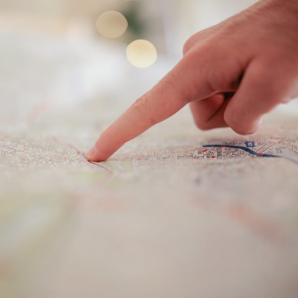Person Pointing on White Textile